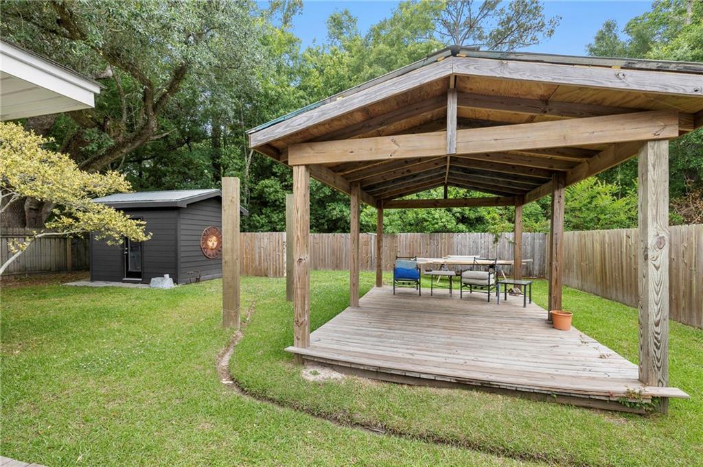 Image 4: Tucked against the side fence is a metal shed.