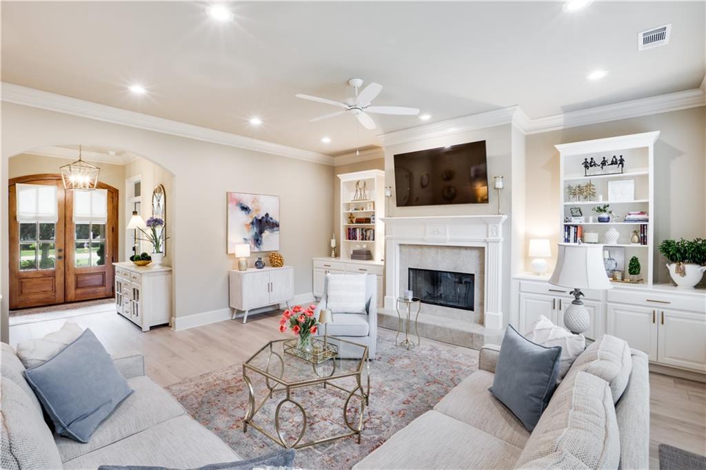 Image 2: DEN WITH WOOD BUURNING FIREPLACE/BOOKSHELVES  ON