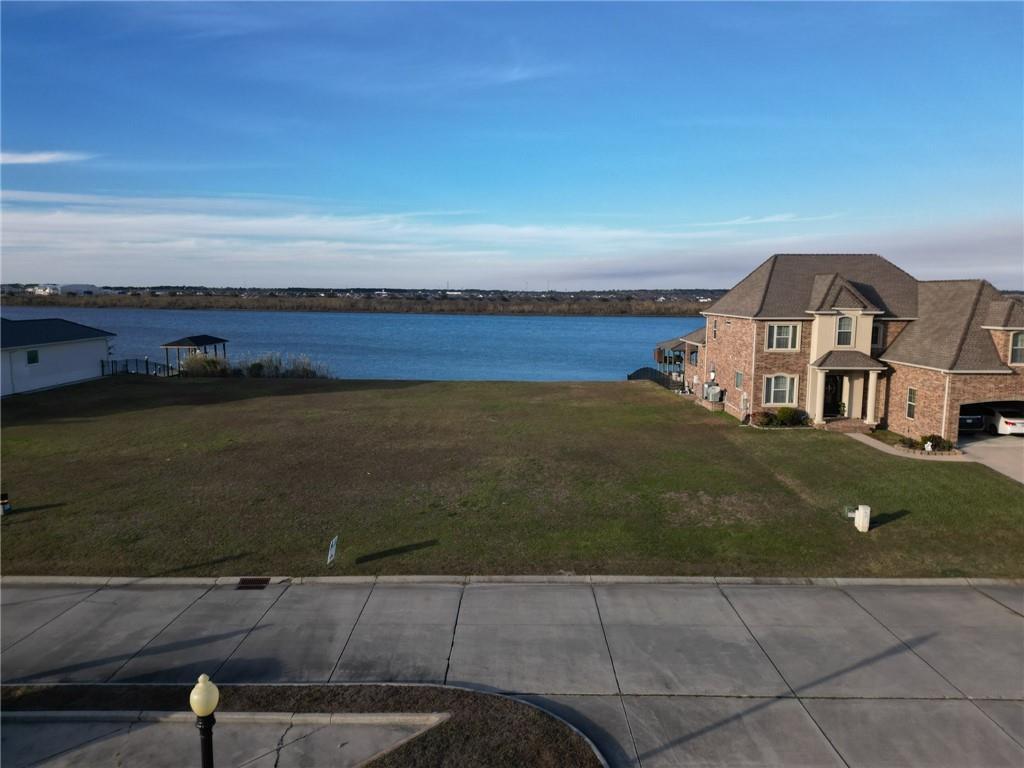 Image 1: Lot is the left half of vacant area-- lot to the r