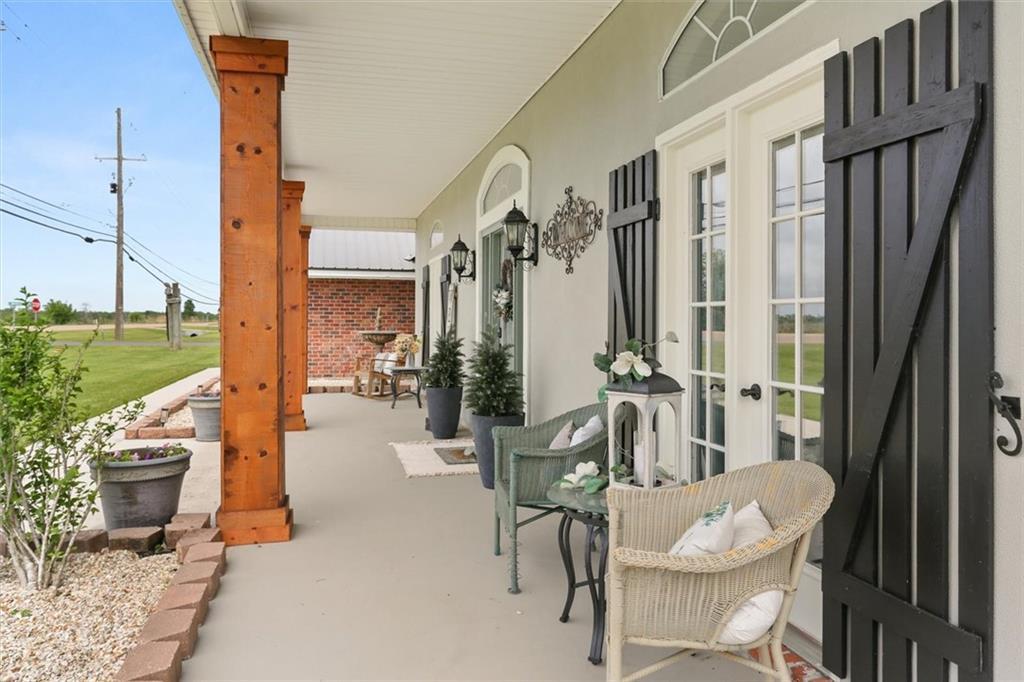 Image 2: Covered front porch at 102 S Bayou Estates South w