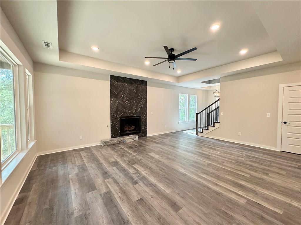 Image 4: Beautiful tiled fireplace, tray ceiling and lvp fl