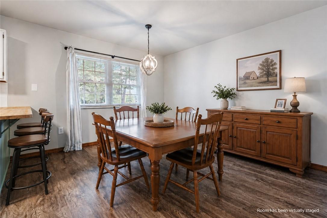 Image 3: Dining area featuring wood-finish flooring, a mult