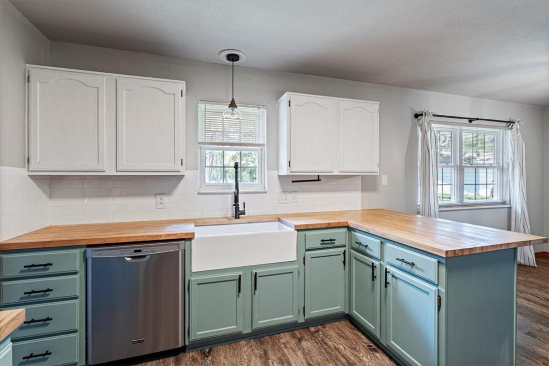 Image 4: Kitchen featuring two-tone cabinetry with white up