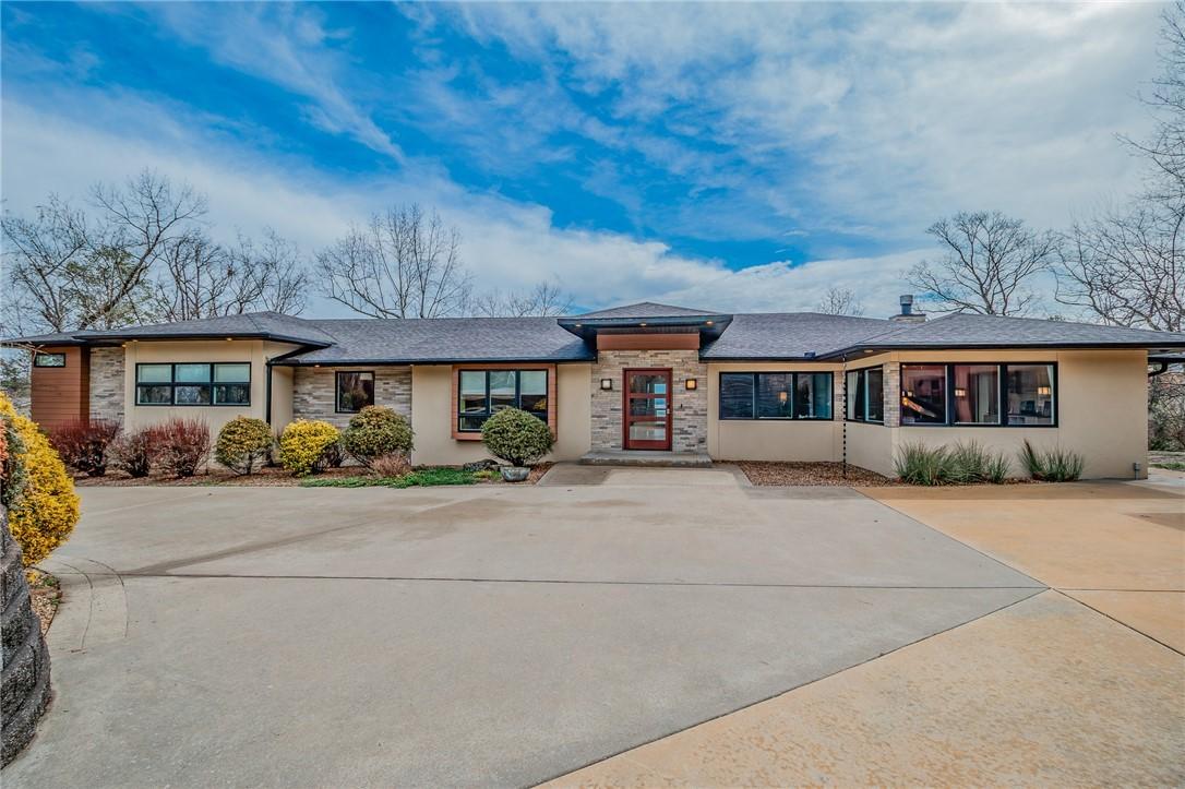 Image 1: View of front of property featuring stone siding,