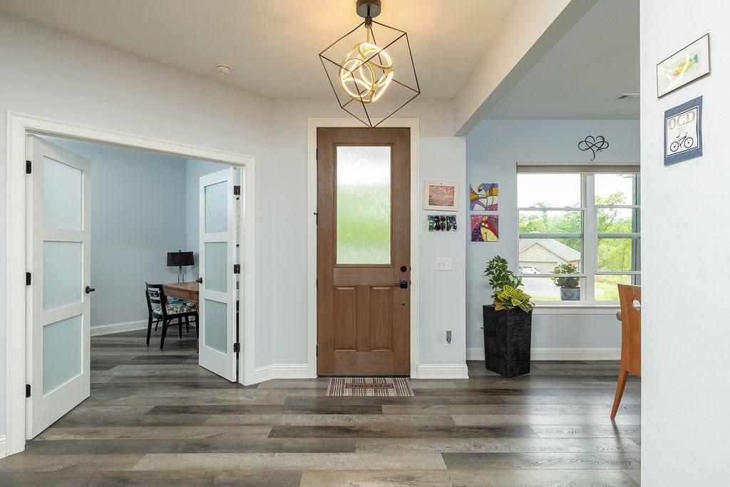 Image 3: Entryway featuring a striking 8&rsquo; wood door with Fl