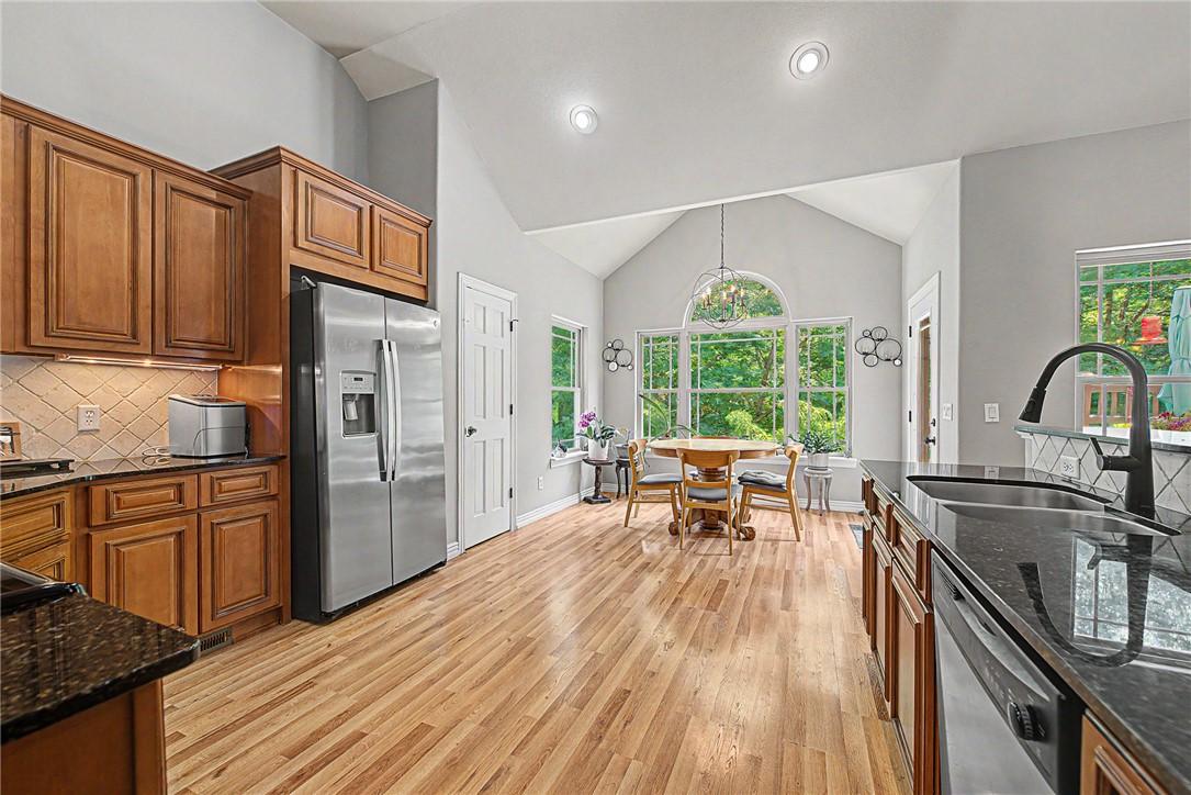 Image 4: Spacious kitchen featuring wood cabinetry, stainle