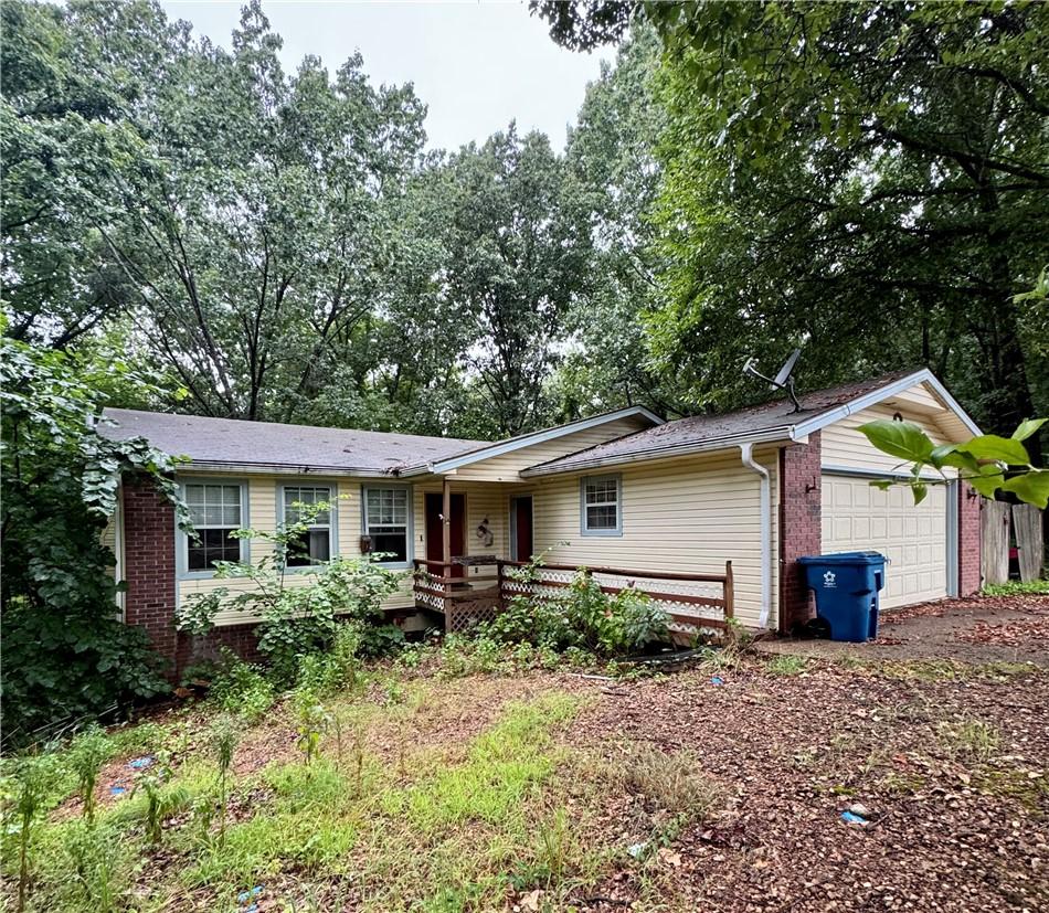 Image 1: Ranch-style residence featuring yellow vinyl sidin