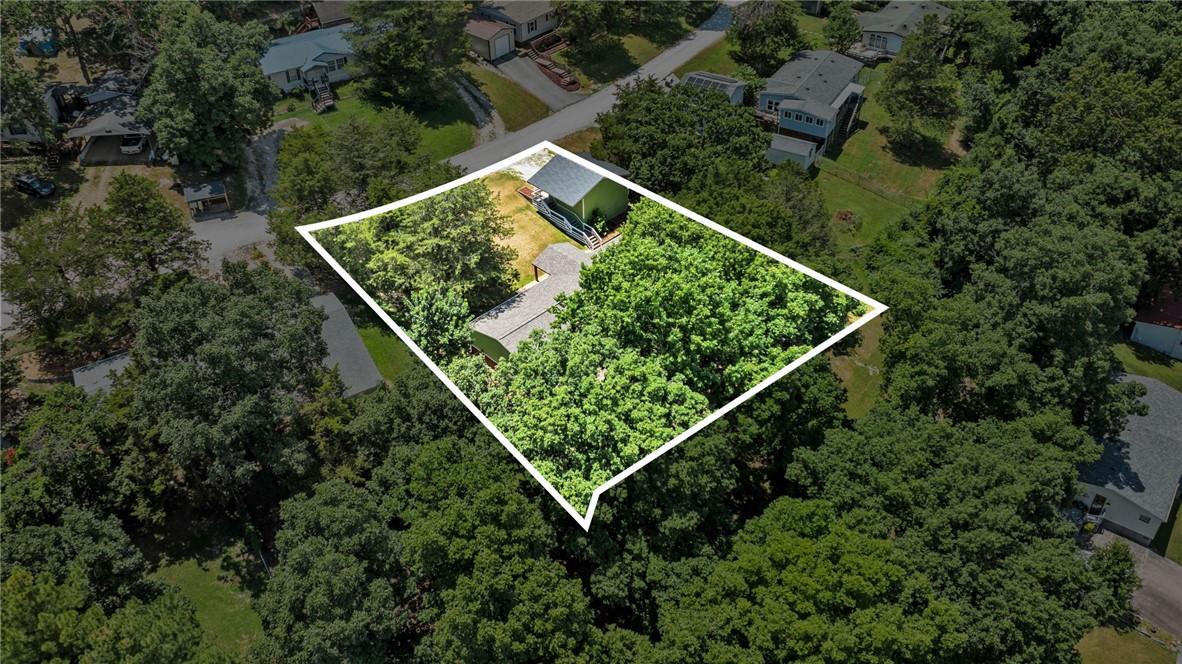 Image 1: Aerial perspective showcasing a property surrounde