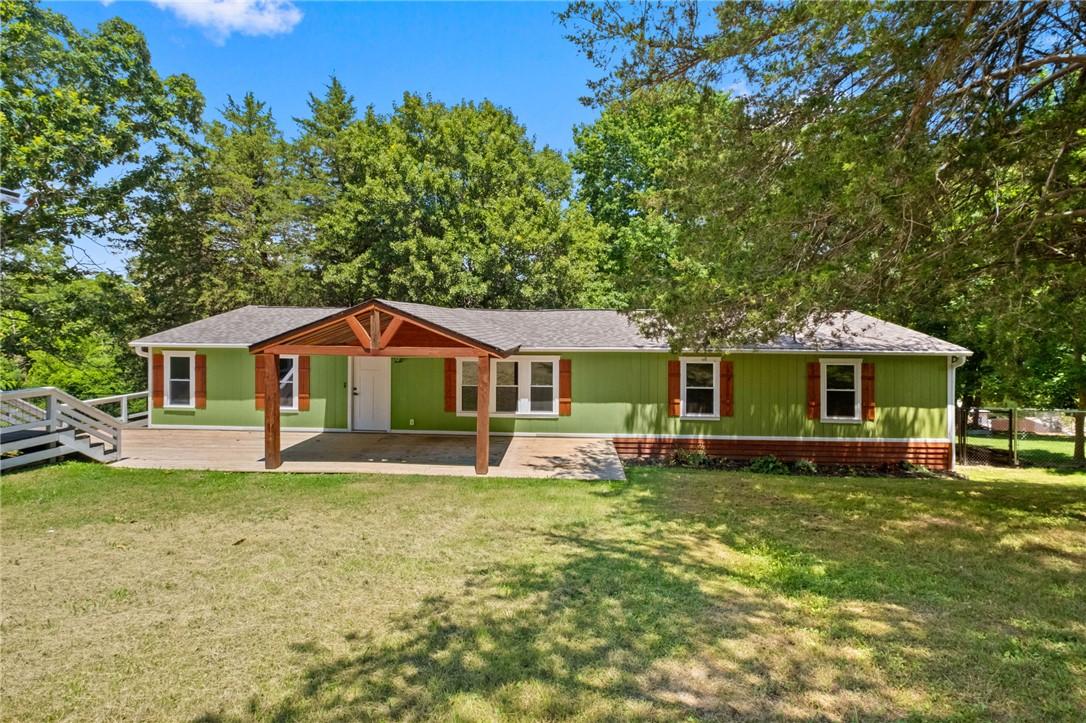 Image 2: Ranch-style residence featuring green siding, a co