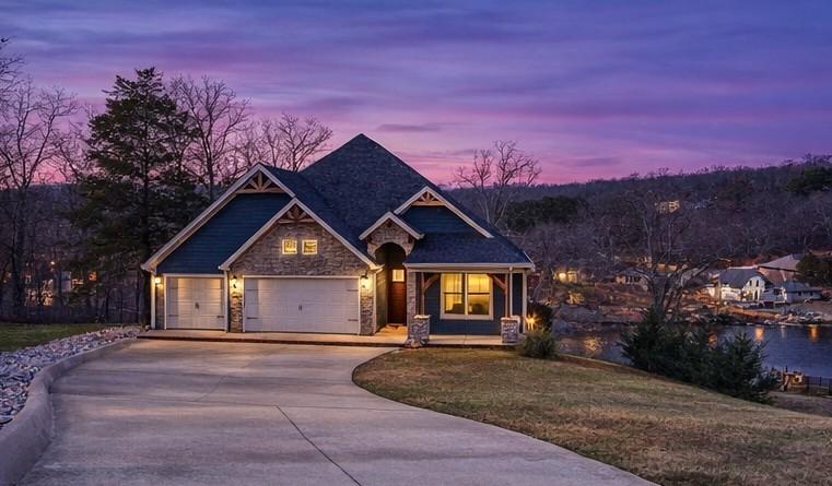 Image 1: Twilight front exterior of lake-view Bella Vista h