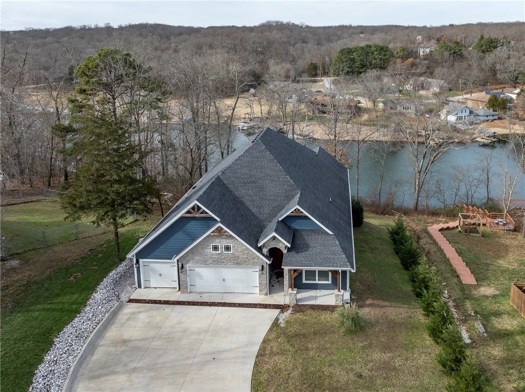 Image 2: Front aerial of the home with elevated lake-view l