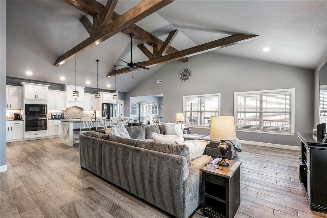 Image 4: Open-concept living room with soaring vaulted ceil