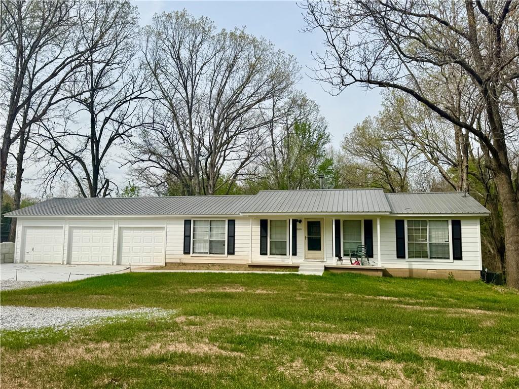 Image 2: Ranch-style home with covered porch, a metal roof,
