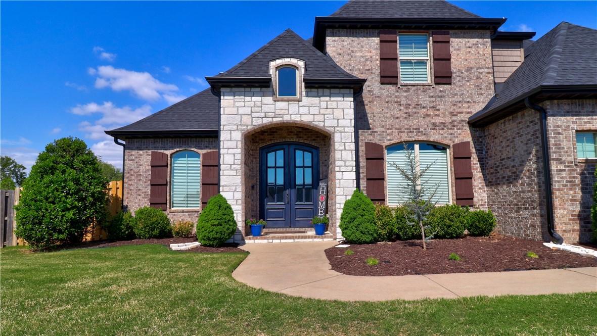 Image 2: Stone and brick with dark blue double entry doors