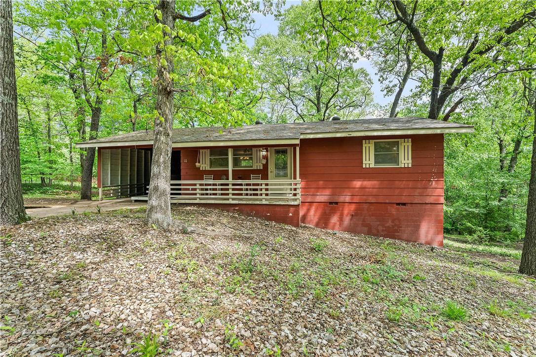 Image 3: Red exterior siding with a covered front porch fea