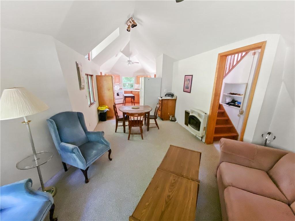 Image 3: Open-concept living area featuring vaulted ceiling