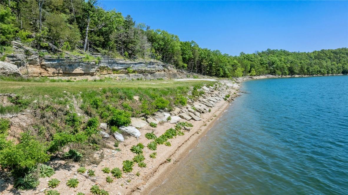 Image 4: Waterfront property featuring a clear blue lake, a