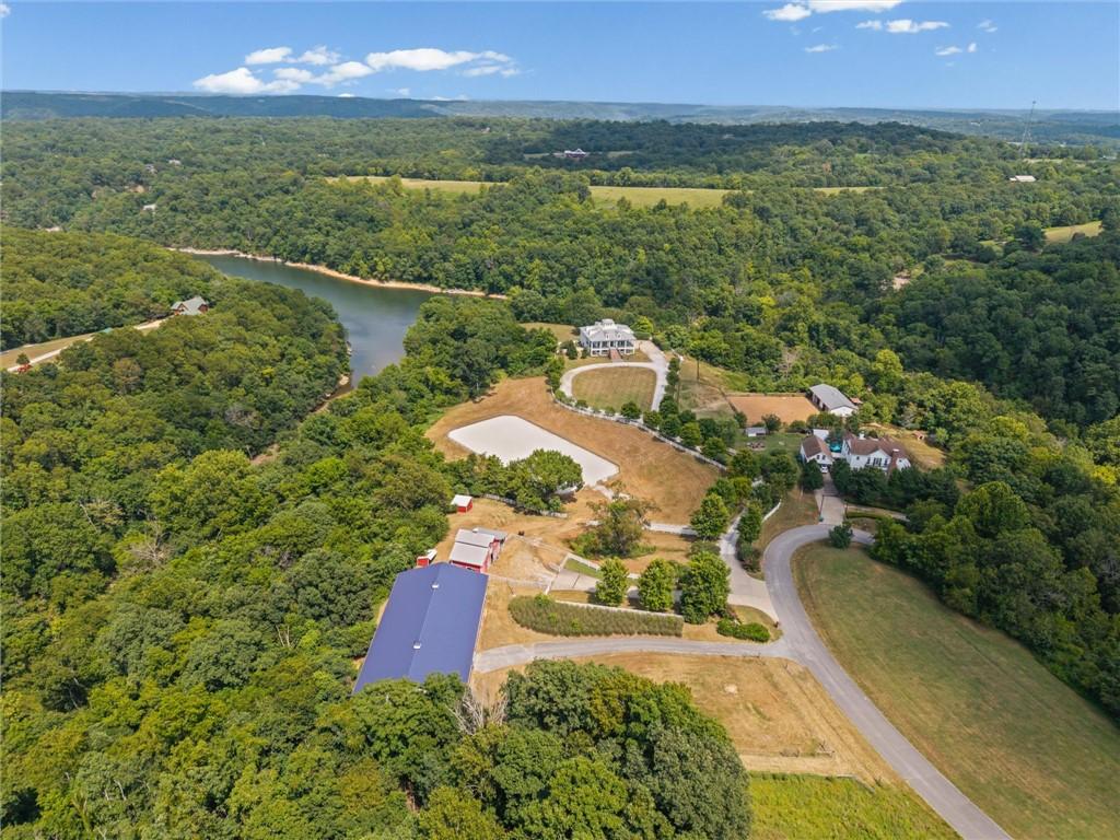 Image 3: Expansive property featuring a large lake, verdant