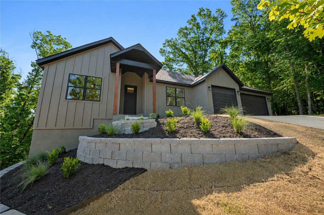 Image 3: Modern exterior featuring vertical siding, a cover