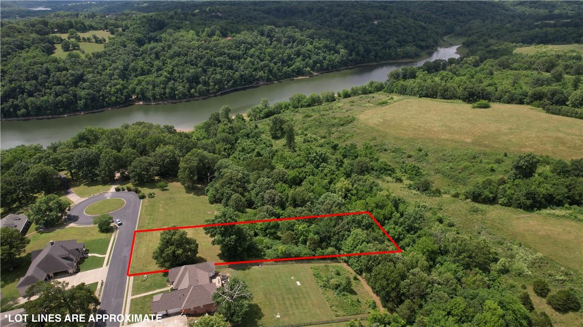 Image 2: Cleared building lot featuring mature trees and a
