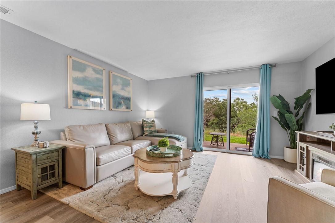 Image 4: Living area featuring light gray wall paint and wo