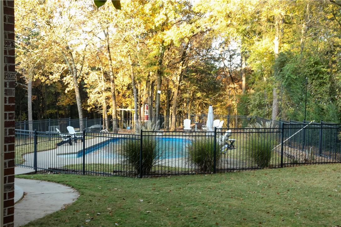 Image 3: Wrought iron fenced pool area