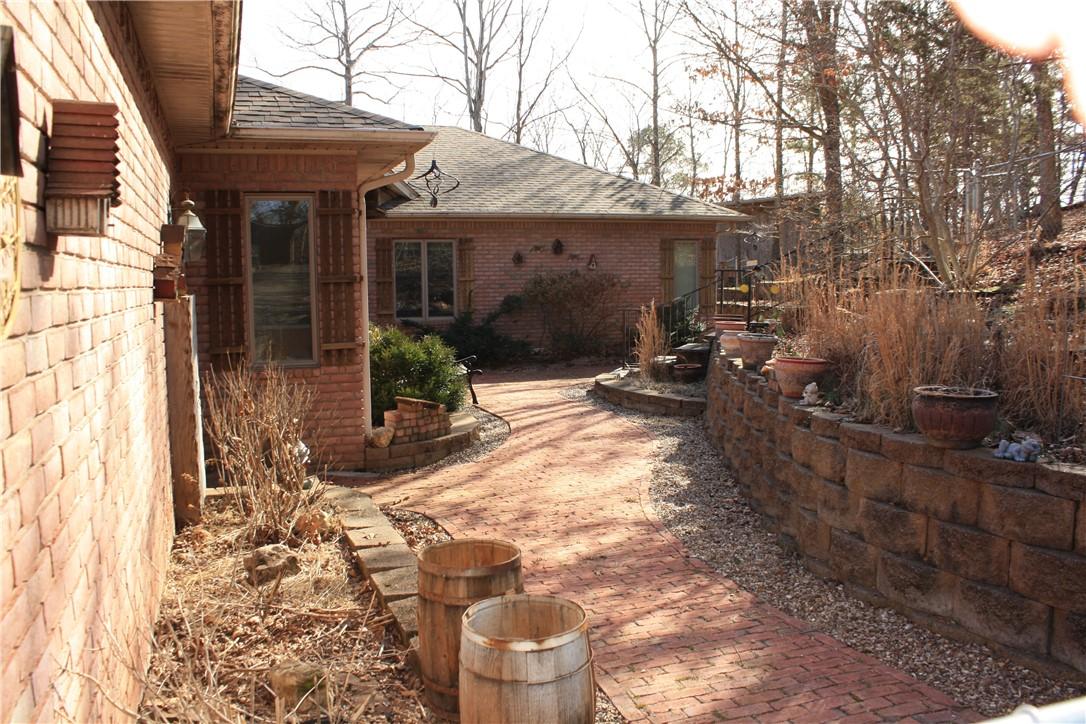 Image 2: View of side of property with a shingled roof and