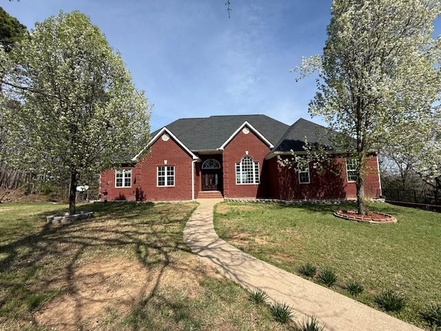 Image 3: Ranch-style home with a front yard and brick sidin