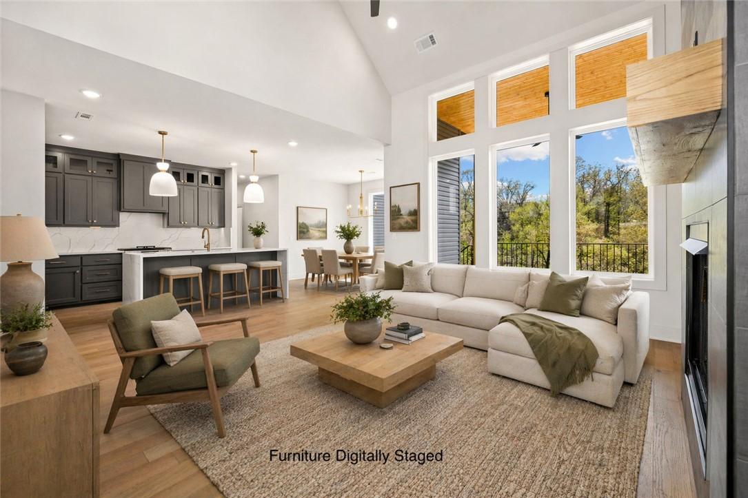 Image 2: Spacious open-concept living area featuring high v
