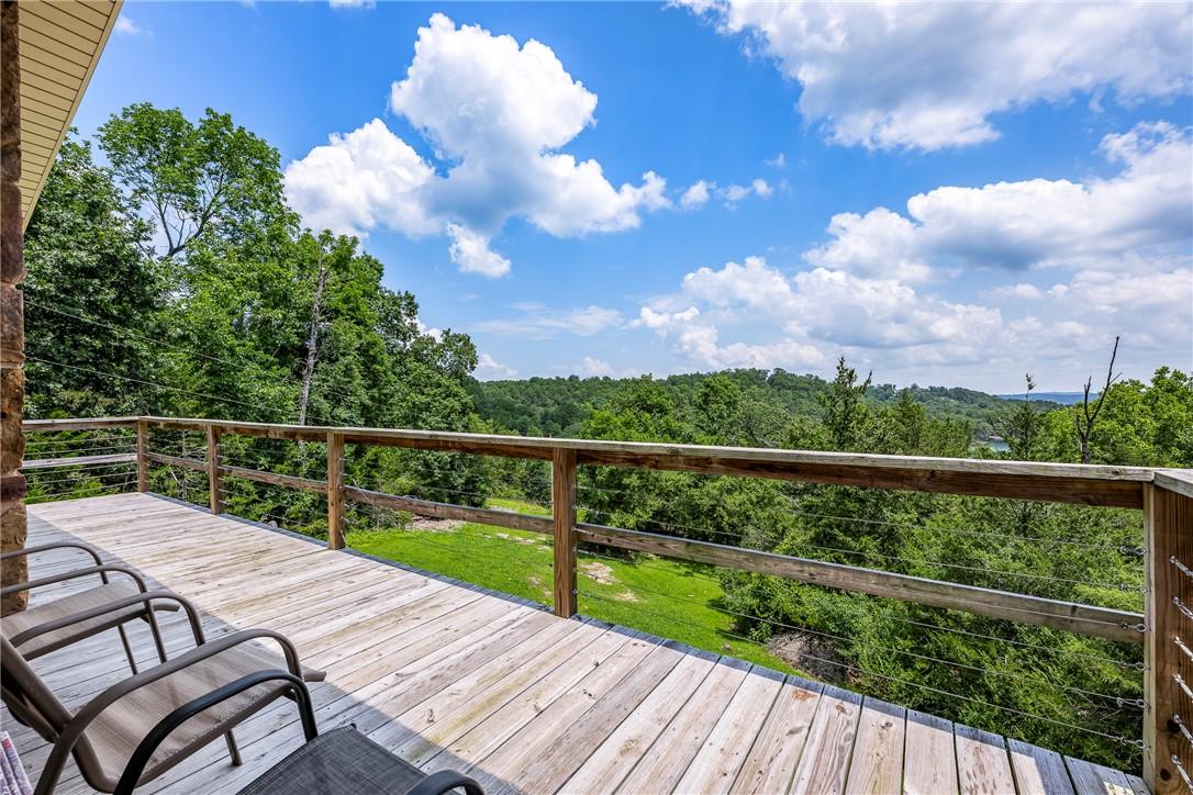 Image 2: Expansive wood-finish deck with wood railings and