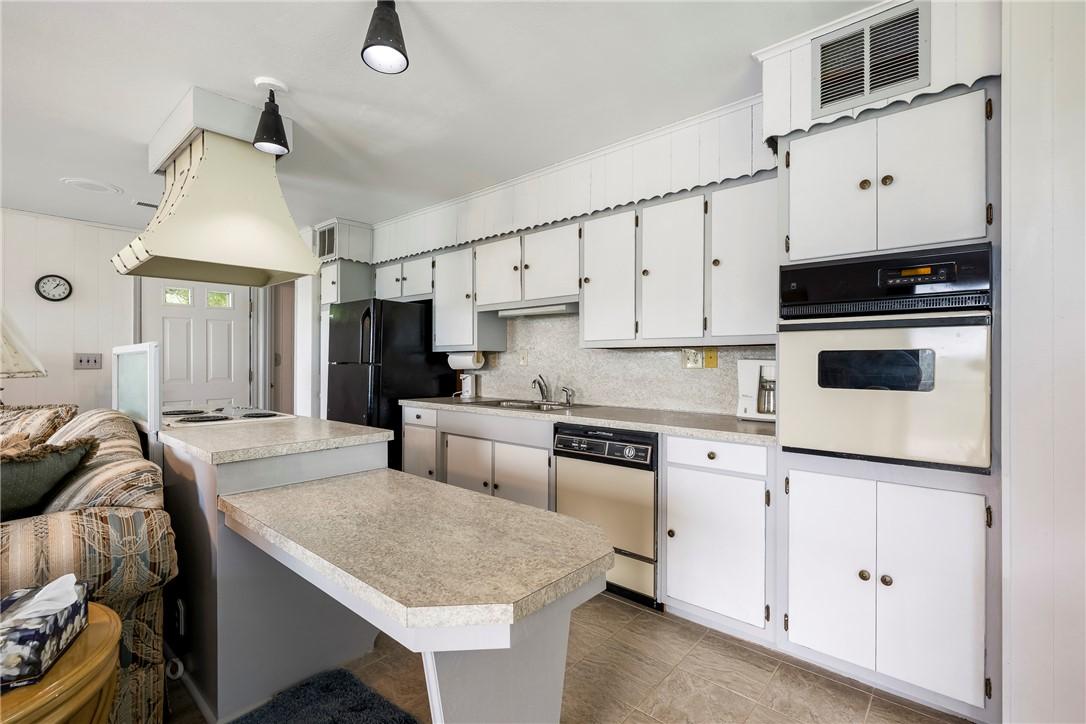 Image 4: Kitchen featuring a built-in wall oven, a cooktop