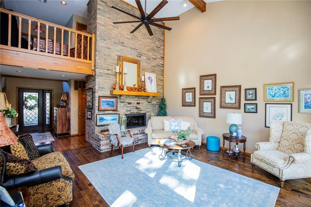 Image 3: Spacious living area featuring a two-story brick f