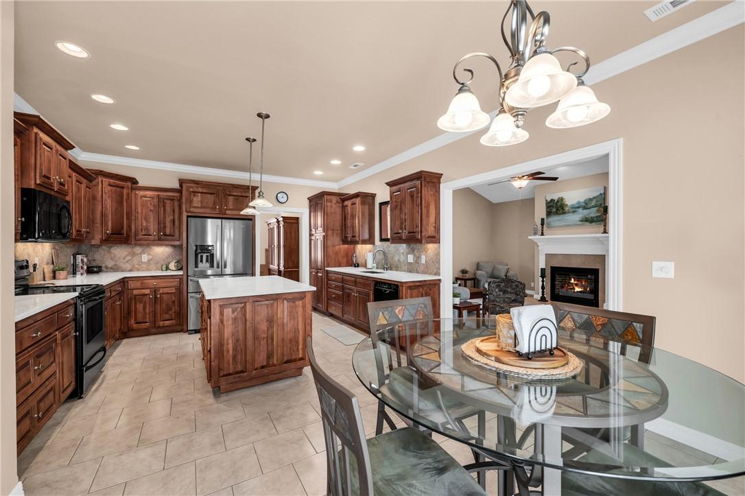 Image 4: Open-concept kitchen and dining area featuring ric
