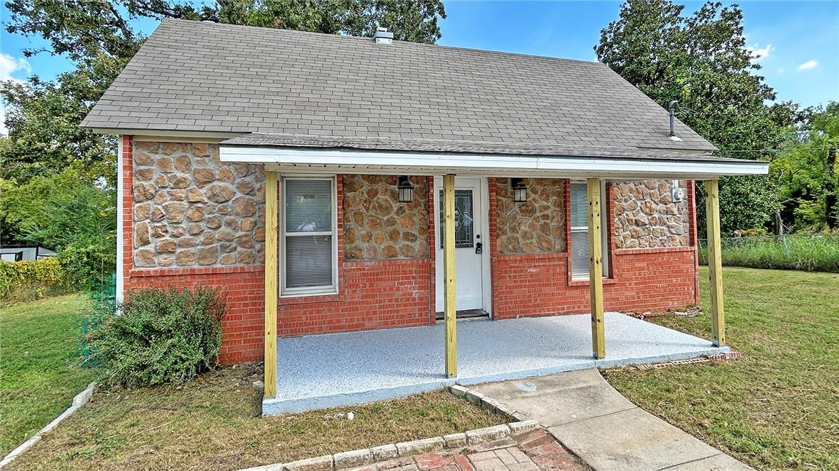 Image 1: Exterior featuring a stone and brick facade, cover