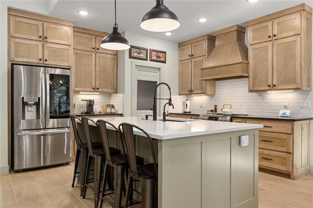 Image 3: Solid wood cabinets in the kitchen add to the natu