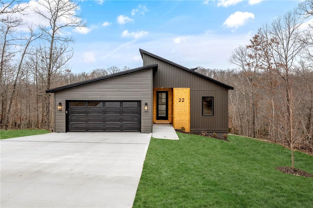 Image 1: View of front of property featuring concrete drive
