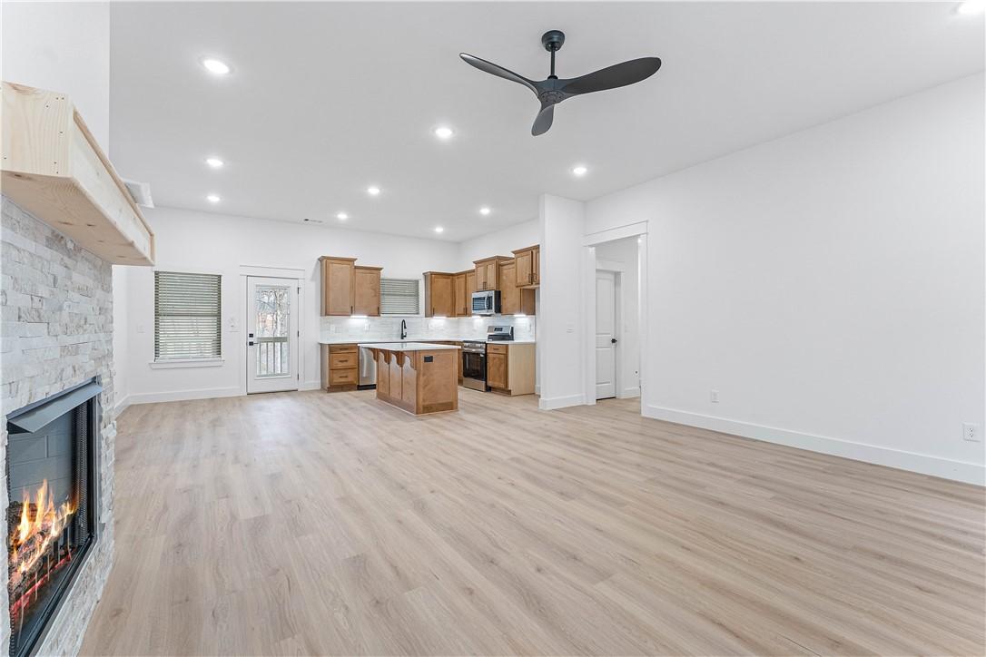 Image 4: Unfurnished living room with a fireplace, a ceilin