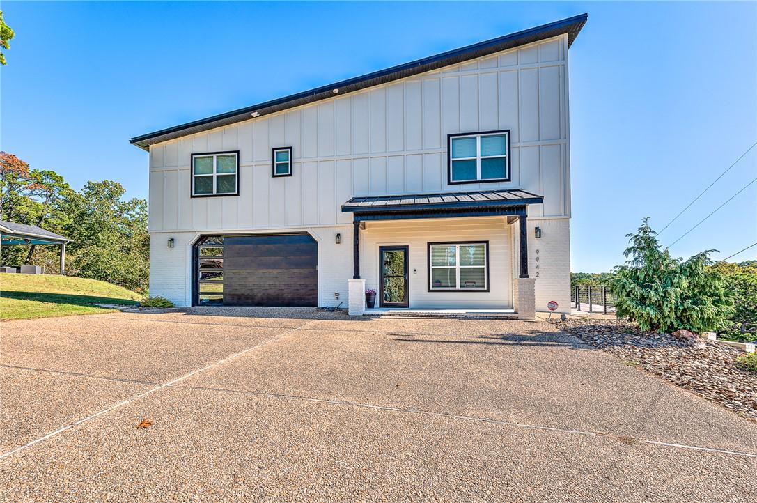 Image 1: View of front of home featuring driveway, board an