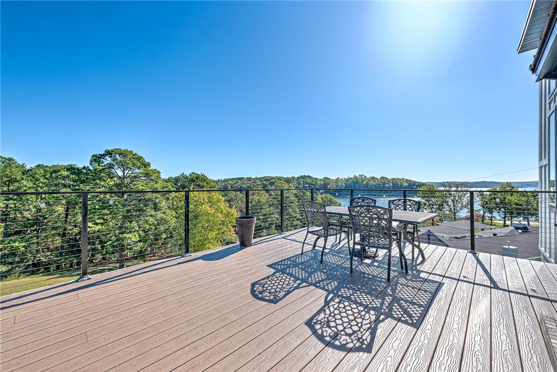 Image 3: Wooden terrace featuring outdoor dining area