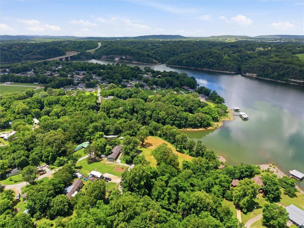 Image 2: Expansive aerial landscape featuring a lake with b