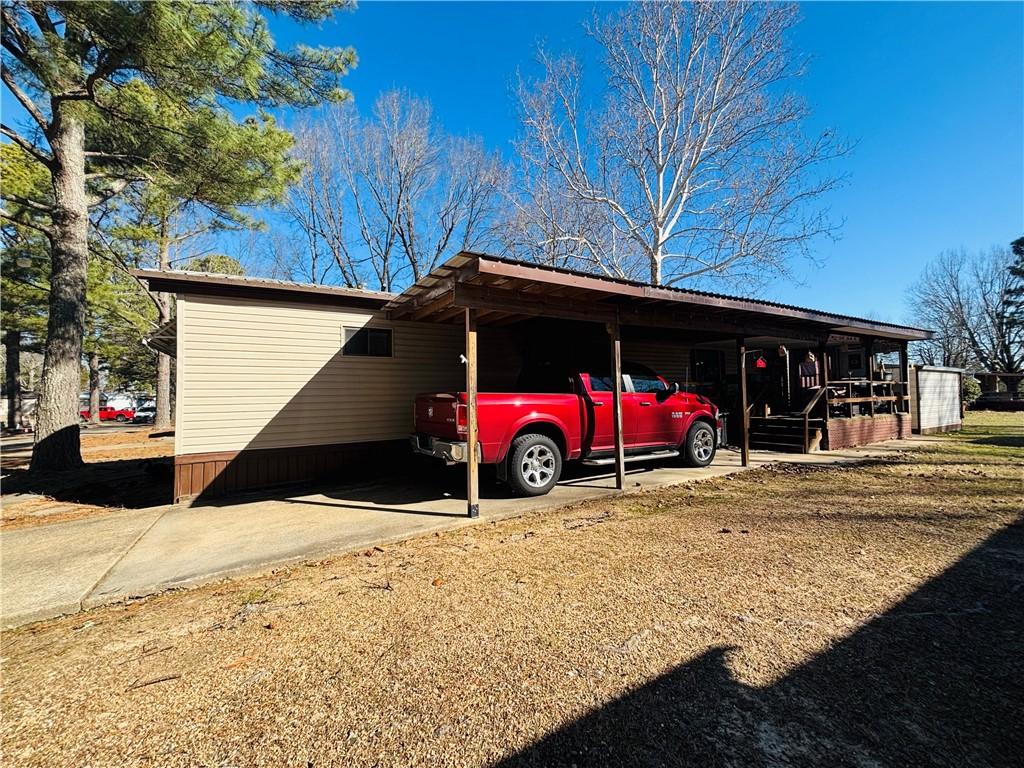Image 2: View of side of property with an attached carport