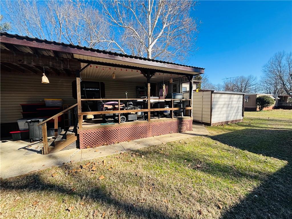 Image 3: Rear view of house featuring a yard, a metal roof,