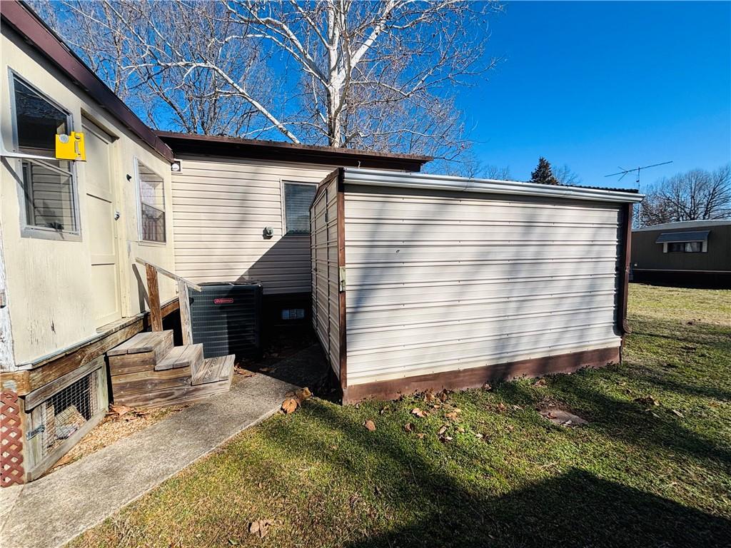 Image 4: View of home's exterior featuring a lawn and a pat