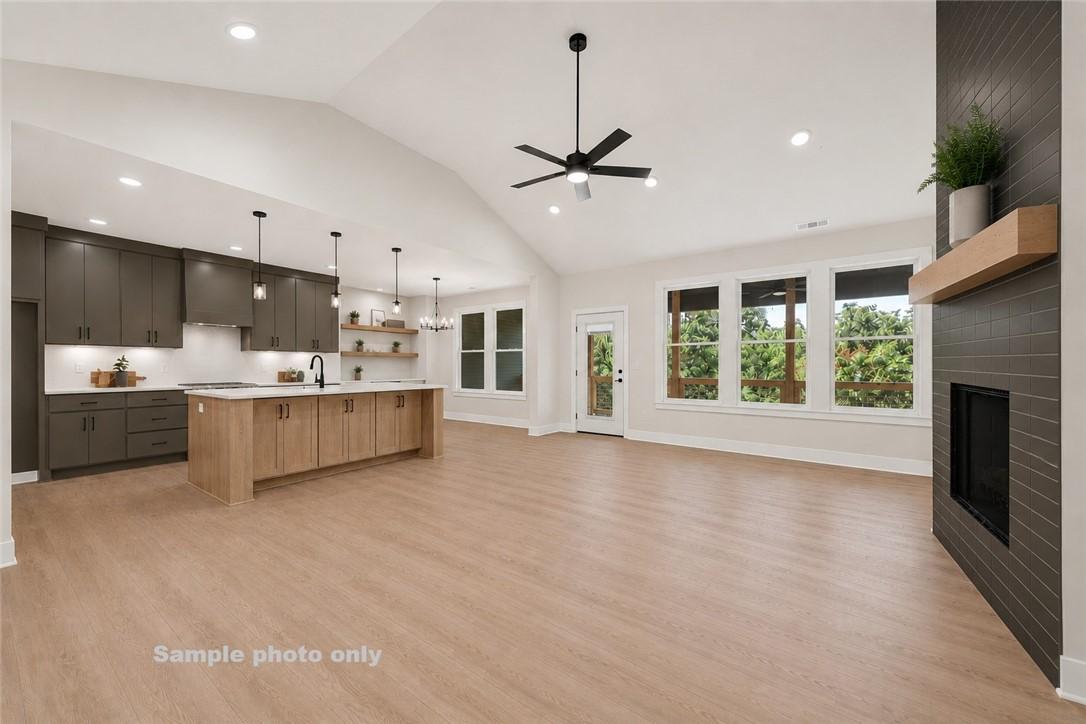 Image 3: Open-concept living area featuring a vaulted ceili