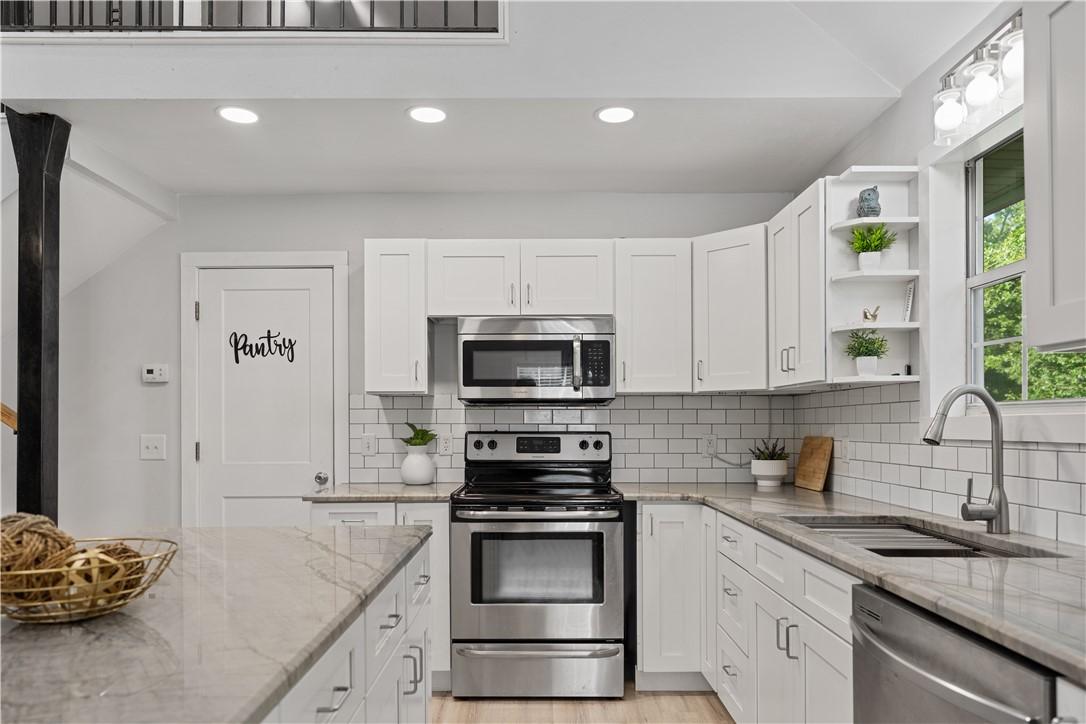 Image 3: Modern kitchen featuring white shaker cabinetry, s