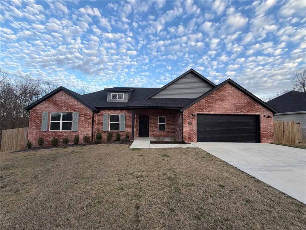 Image 1: View of front of house with a porch, brick siding,
