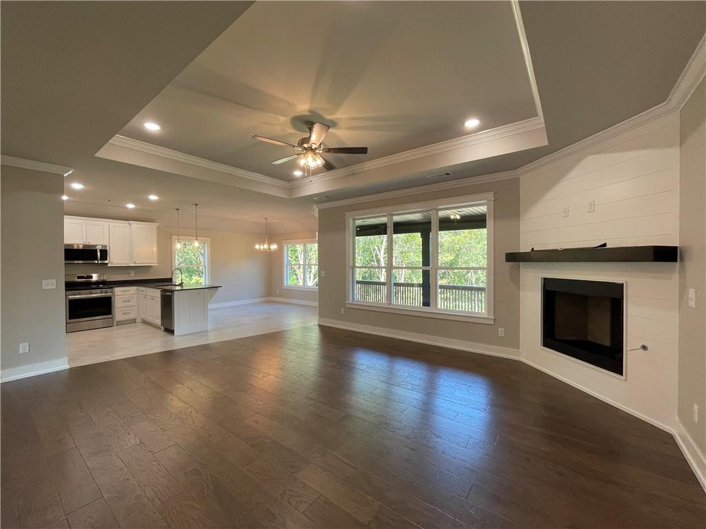 Image 4: Living room featuring crown molding, a ceiling fan