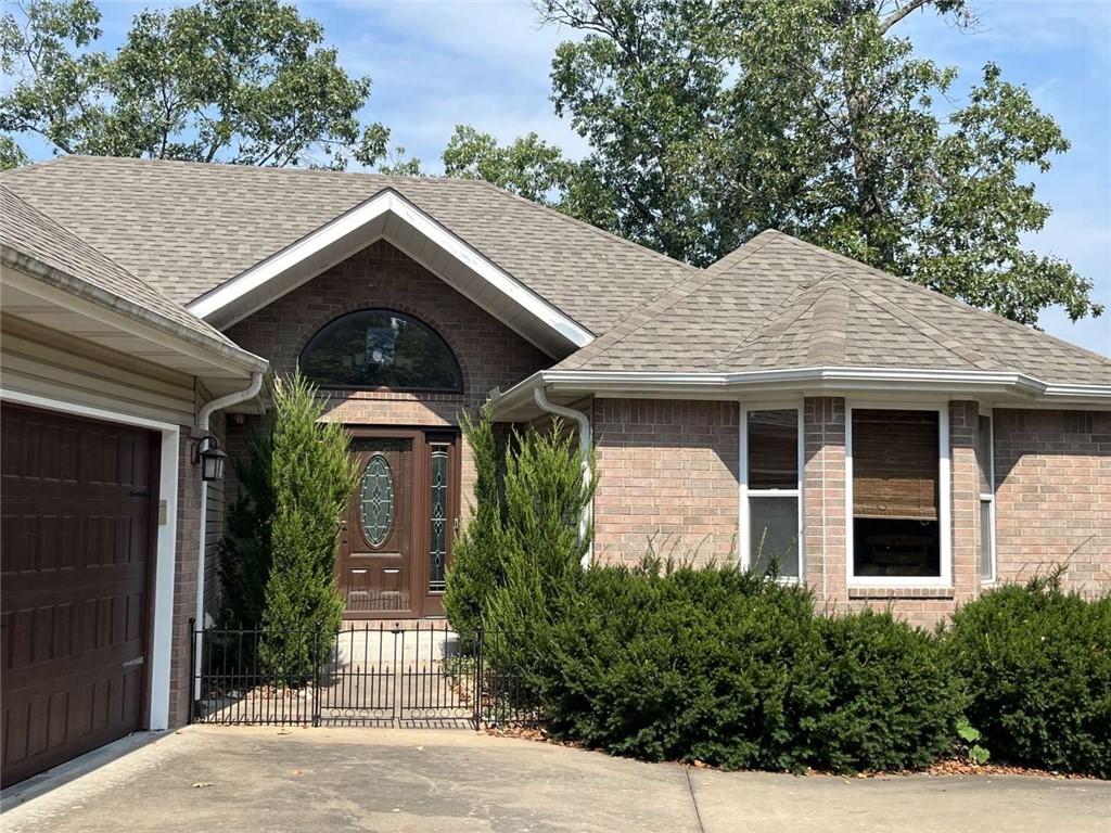 Image 1: Entrance to property featuring roof with shingles,
