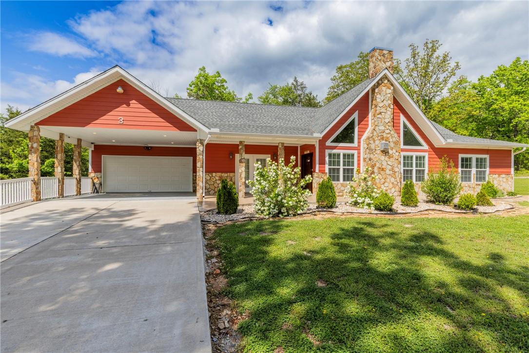 Image 1: Contemporary red-sided residence with stone accent