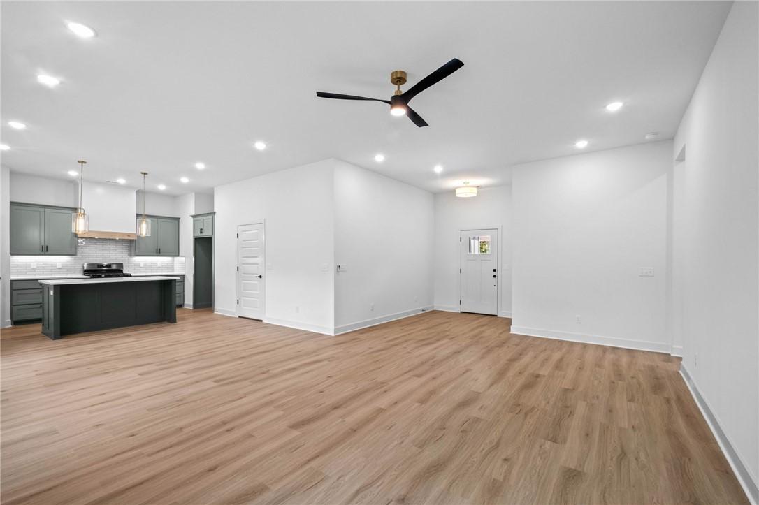 Image 4: Open-concept living space featuring wood-finish fl